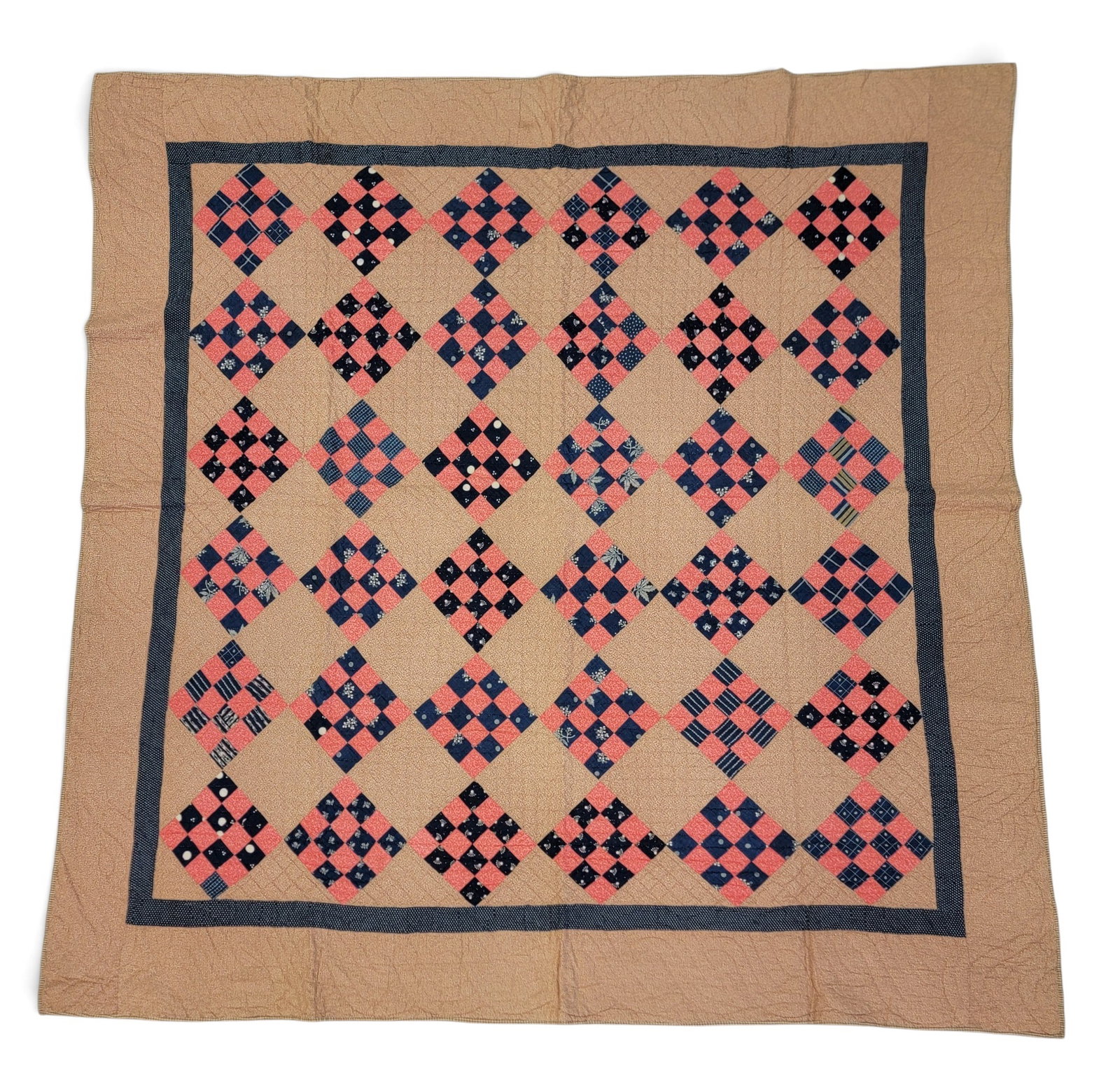SIXTEEN-PATCH QUILT: American, 2nd half-19th century. Squares of blue and red prints, against a printed brown ground, and with a checked brown back. 79" by 78". Provenance: an Ohio collection. NOTE: We are happy to