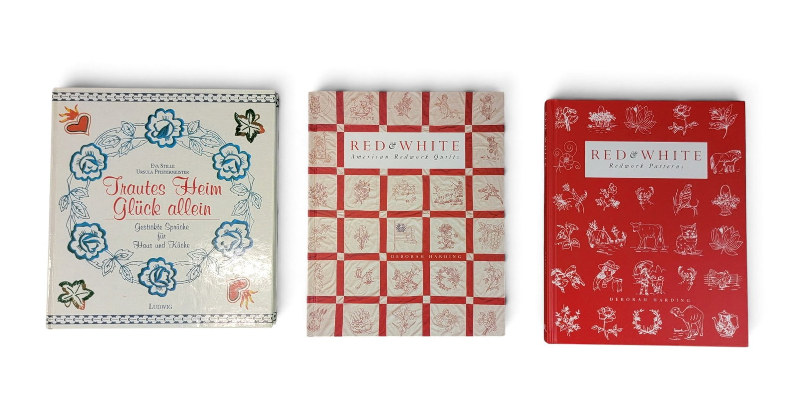 TWO REFERENCE BOOKS ON TEXTILES: Includes Deborah Harding, Red and White: American Redwork Quilts and Patterns, Rizzoli, 2000, 2 volumes; together with Eva Stille, Trautes Heim Glueck Allein: Gestickte Sprueche fuer Haus und Kueche,