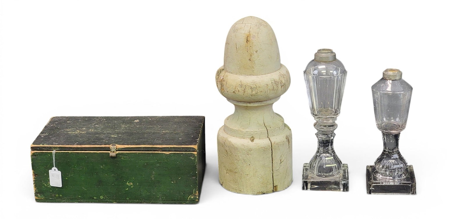 BOX, FINIAL, AND TWO WHALE OIL LAMPS: American, 19th century. Includes a square-nailed box in original green paint, 11" wide; together with an acorn post finial in old white paint, 12'" high; and two flint glass lamps with square bases,