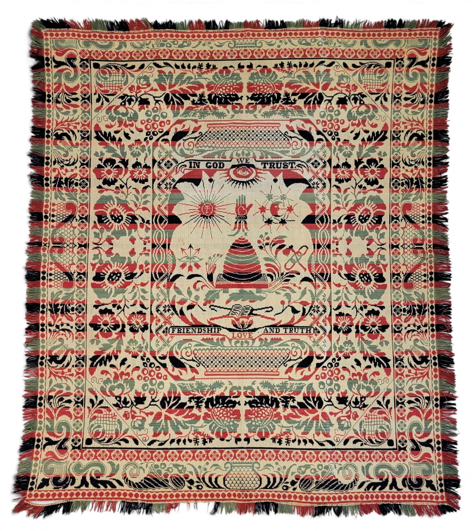 UNUSUAL ODD FELLOWS JACQUARD COVERLET: American, mid-19th century. Single loom width, in red, dark blue, light blue, and natural. Central bee skep with "IN GOD WE TRUST", sun, moon, and heart-in-hand above and book and "FRIENDSHIP LOVE AND