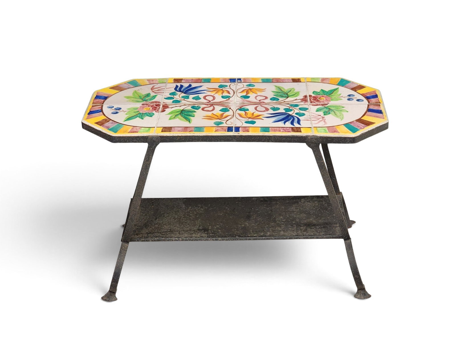 CALIFORNIA TILE-TOP TABLE: 1st half-20th century. With a floral-decorated tile top and wrought-iron base. 20.25" high, 32" wide, 16" deep. Provenance: a New York State collection NOTE: We are happy to answer questions and take