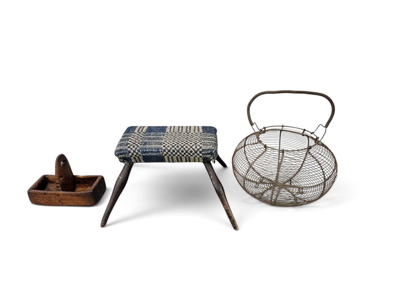 STOOL, BASKET, AND SMALL BOX: American, 19th century. Includes a windsor stool with splayed legs and overshot upholstery, 16" wide; a wire egg basket, 12" diameter; and a small, 18th century box, the body carved from the solid,
