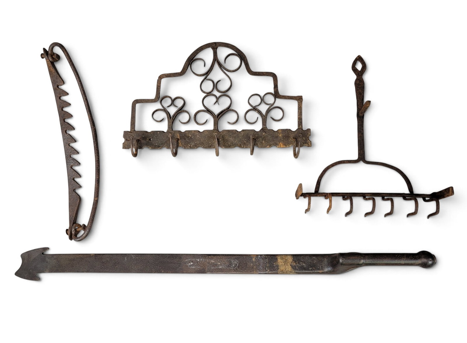COLLECTION OF EARLY AMERICAN IRON: 19th century. Includes a ratchet adjuster, a cooking implement, a wrought-iron hanging rack, and a tool used by slate roofers by Stortz of Philadelphia. Roofing tool is 32.5" long. John Stortz and