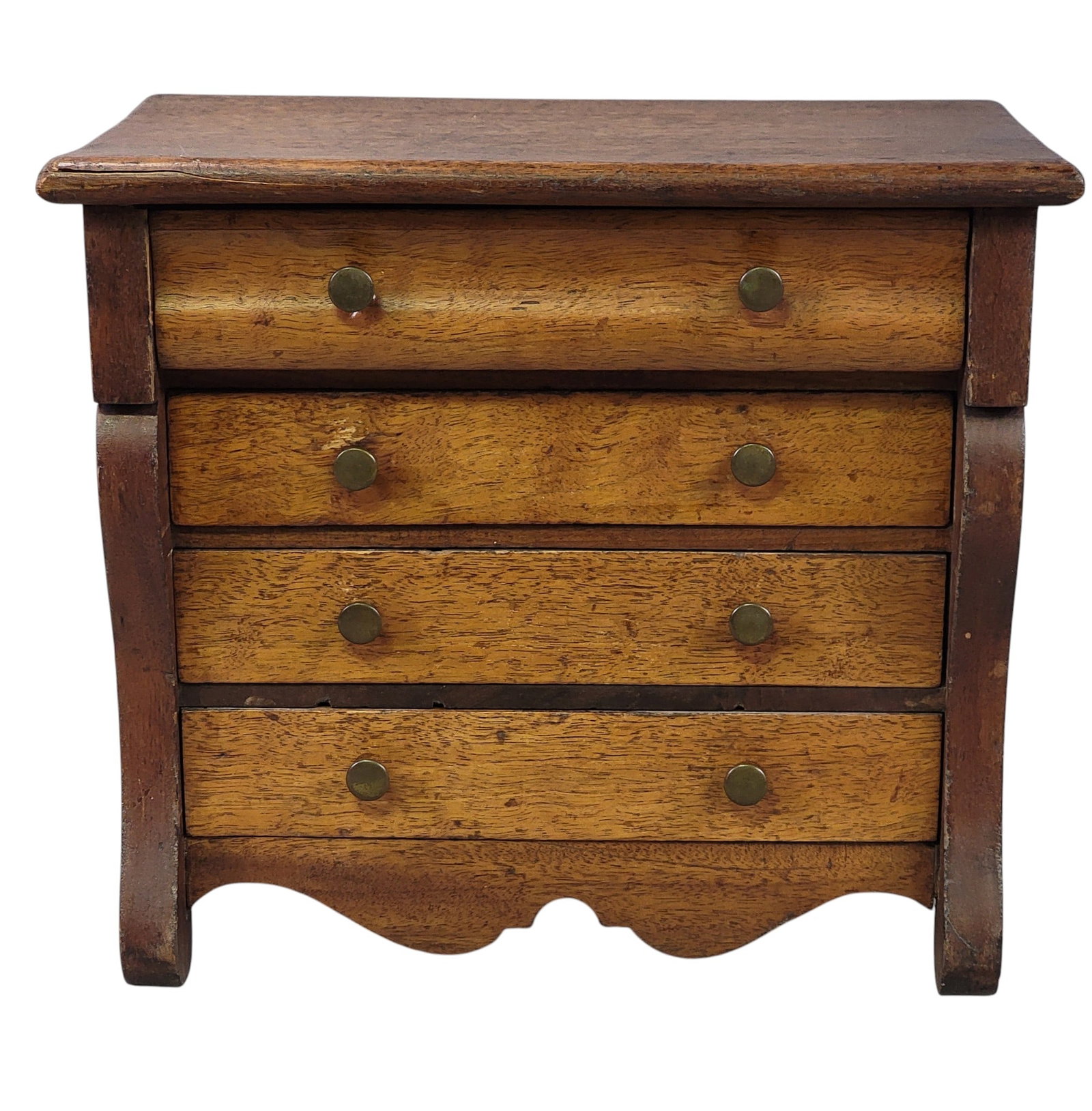 MINIATURE CLASSICAL CHEST OF DRAWERS: American, 19th century, walnut and pine. Shaped top drawer over three drawers, flanked by scrolled pilasters and on scrolled feet. 10" high, 11.5" wide, 7.5" deep. Provenance: an Ohio collection. NOTE
