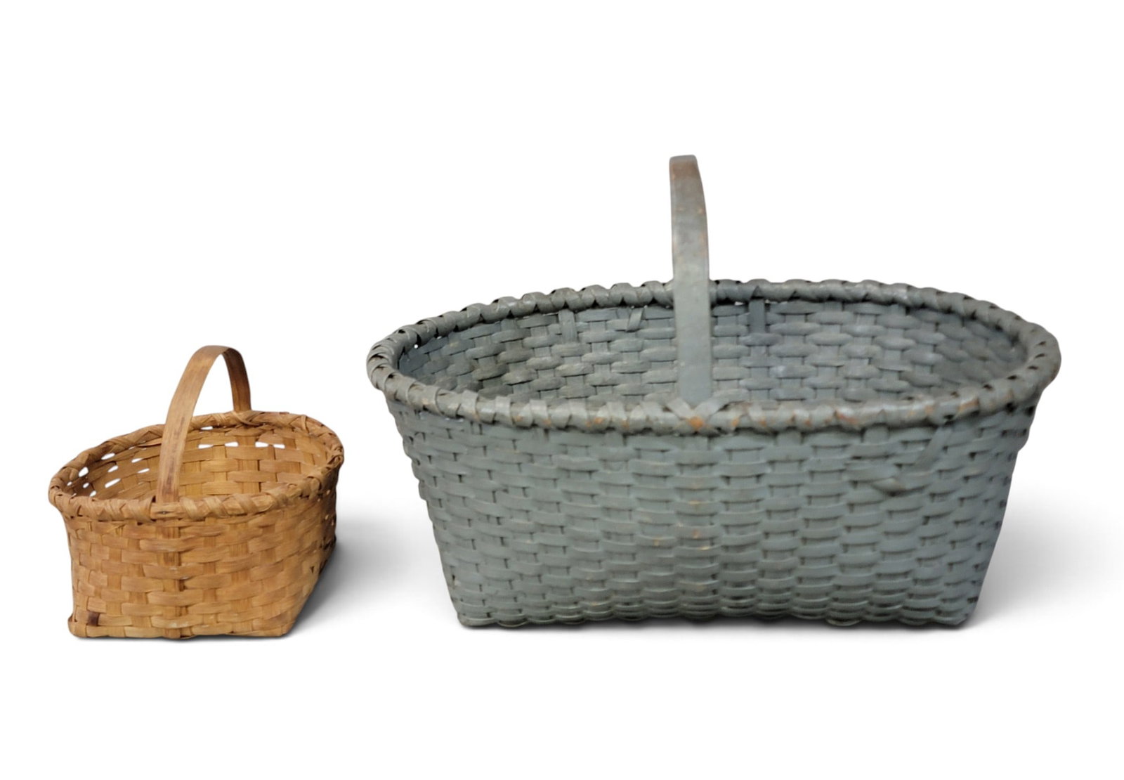 TWO EARLY BASKETS: American, late 19th-early 20th century, woven splint with bentwood handles. Includes a smaller basket with an inscribed note that it was "Bought at Bishopville [South Carolina] Apr. 23 '38"; 9"