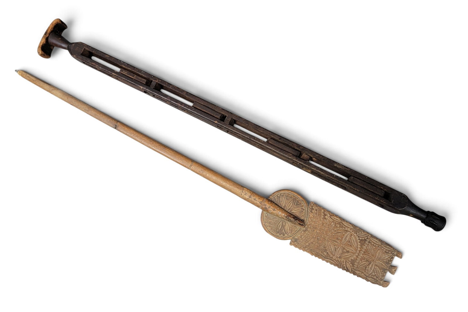 TWO FOLK ART CARVED ITEMS: 19th century. Includes an American walking stick with captured blocks and original finish, 35" long; together with a chip-carved distaff, incised "AMM" on the back side, 35" long. Provenance: a