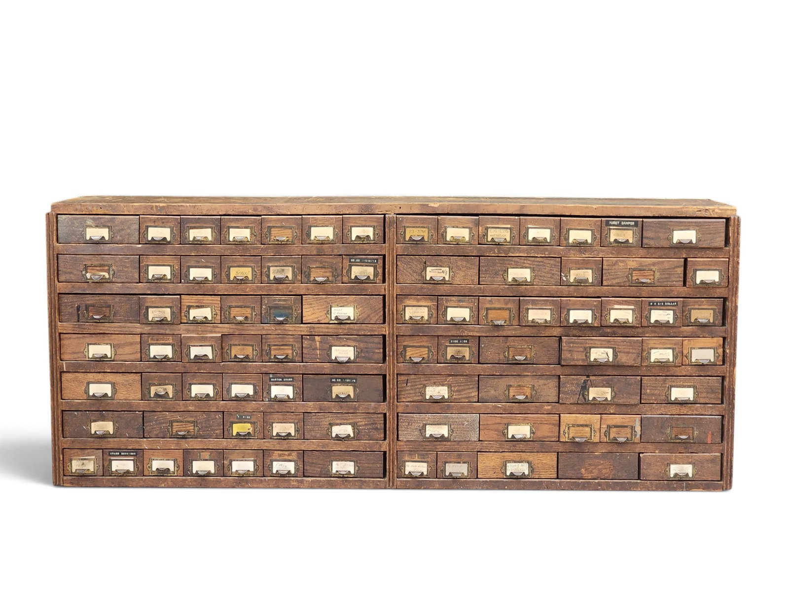 BICYCLE SHOP HARDWARE CABINET: American, early 20th century, pine. A double-wide case, with a variety of small and medium drawers in flexible configurations, some labeled. 21" high, 50.5" wide, 12.5" deep. Originally used in A.R.