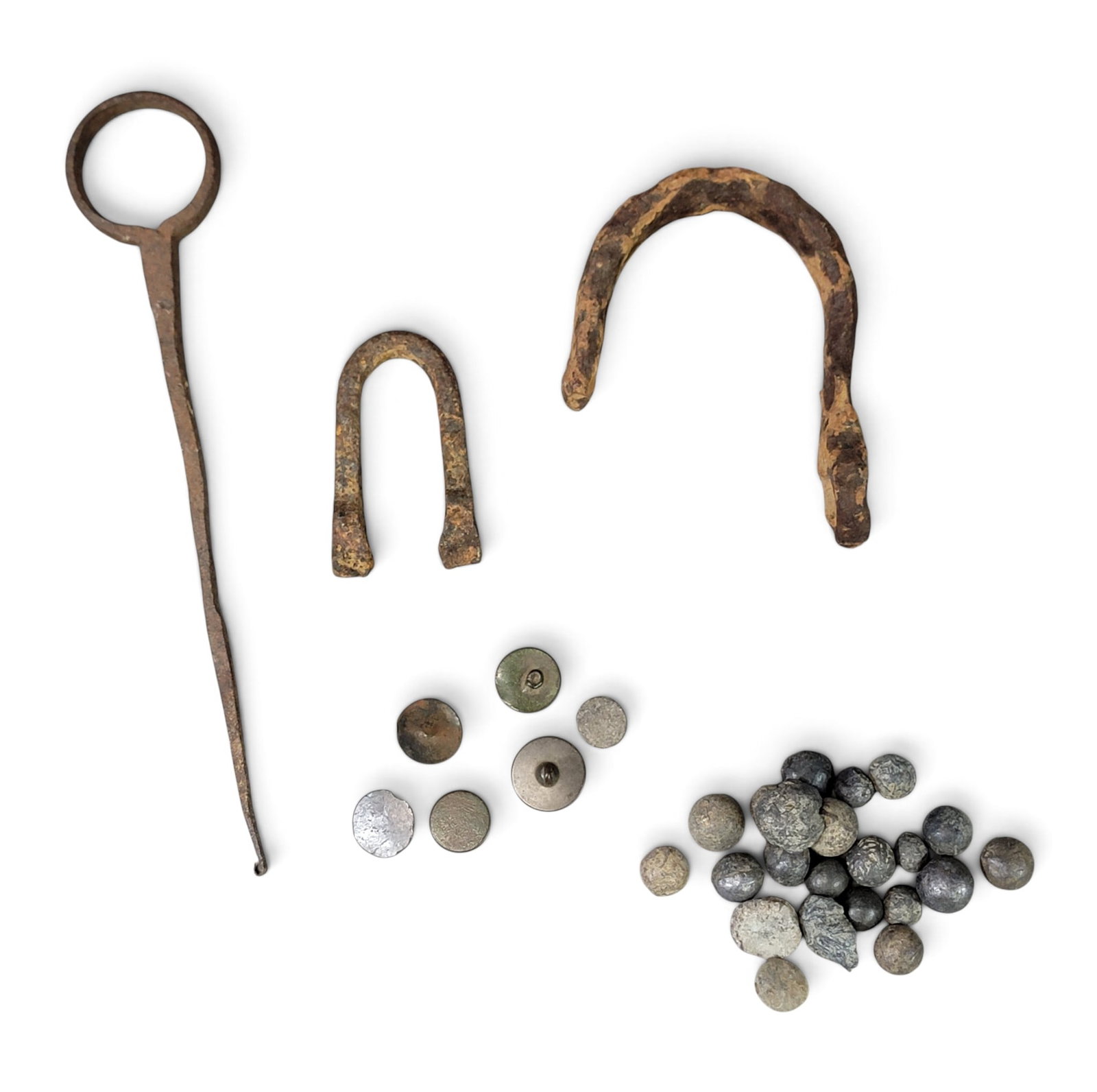 COLLECTION OF WOOD COUNTY, OHIO MILITARY RELICS: Includes 6 buttons and a collection of musket balls dug as surface finds below Fort Meigs; together with three pieces of dug iron from along the Maumee River. Provenance: a Pennsylvania collection.