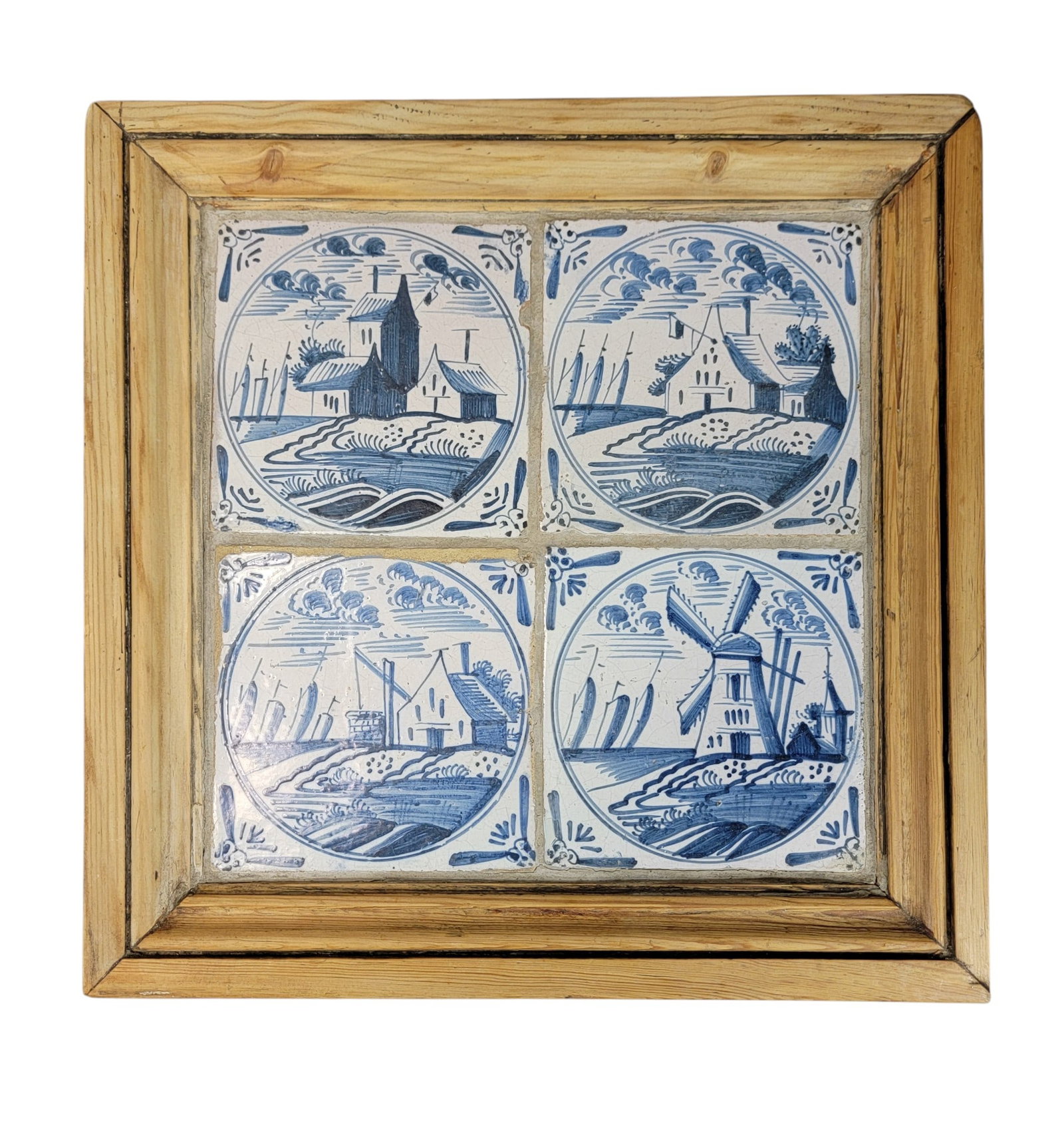 SET OF FOUR FRAMED DELFT TILES: Netherlands, 18th-19th century, tin-glazed earthenware. Blue and white, with houses, a windmill, and a well with a shaduf. Framed, overall 14" square. Provenance: an Ohio collection. NOTE: We are happ