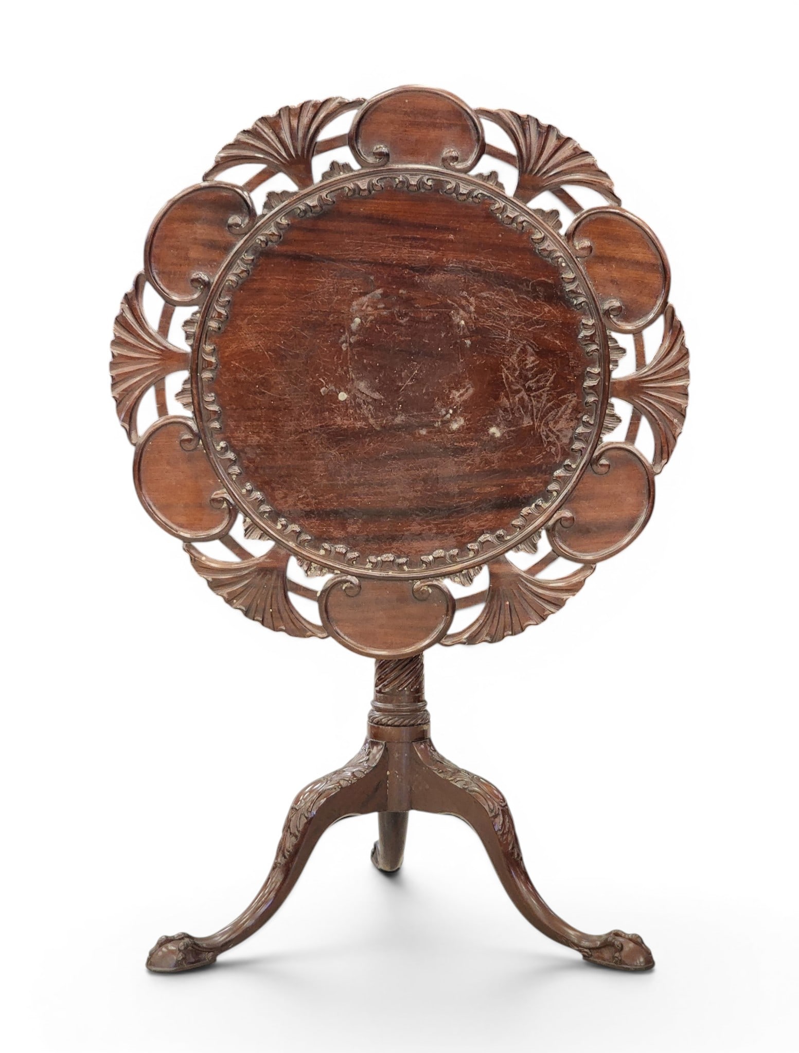 CARVED CHIPPENDALE-STYLE TILT-TOP TEA TABLE: 19th century, mahogany. Elaborately carved top with openwork edge, spiral-turned column, and carved cabriole legs ending in ball and claw feet. 28.5" high, 29" diameter. Provenance: a Kentucky