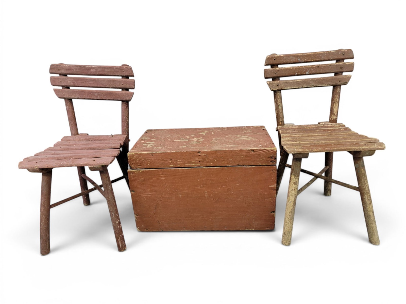 TWO CHILD'S CHAIRS AND A PAINTED BOX: 19th-20th century. includes a pair of slatted child's chairs in old red paint, 23.25" high; together with a box or trunk in old red paint, 12" high, 19.5" wide, 11.25" deep. Provenance: a Kentucky