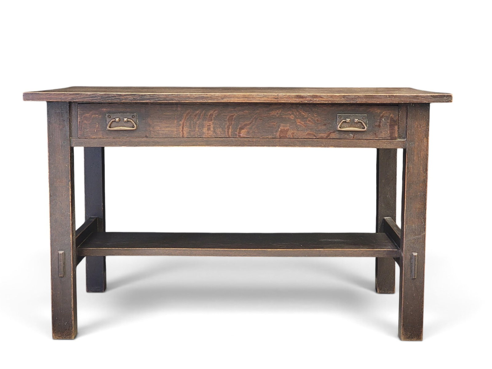 L & JG STICKLEY ARTS & CRAFTS LIBRARY TABLE: Early 20th century, oak. One long drawer over a lower shelf with mortise and through-tenon supports. 29" high, 48" wide, 30.25" deep. Provenance: a Michigan collection. NOTE: We are happy to answer qu