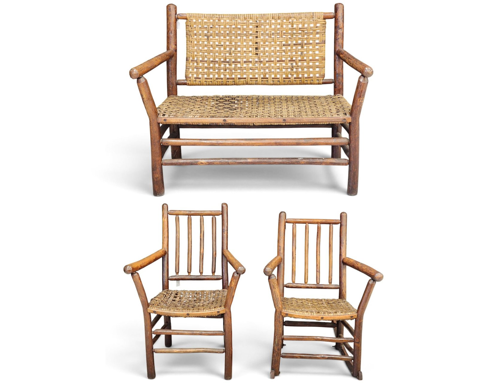 OLD HICKORY ADIRONDACK SETTEE AND CHAIRS: Martinsville, Indiana, 1930s. Inlcludes a settee, 44.5" long, an armchair, 36" high, and a rocking chair, 34.5" high. Retain their original finish. Provenance: a southeast Pennsylvania collection.