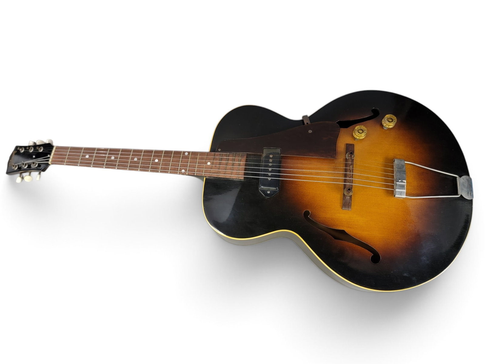 1952 GIBSON ES125 HOLLOW BODY ELECTRIC GUITAR: Sunburst, single P90 pickup, s/n Z2495. 40" long. In an original Gibson case. Provenance: a southwest Ohio collection; mostly collected at local farm and estate auctions. NOTE: We are happy to answer