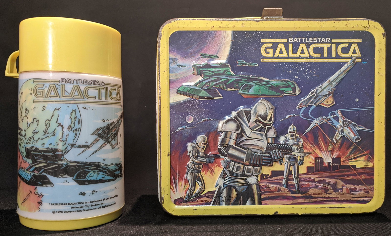 1978 Battlestar Galactica LUNCHBOX & Thermos Cylon: Embossed Vintage Metal Lunch Box with images from the classic sci-fi TV series Battlestar Galactica starring Lorne Greene and Richard Hatch as leaders of a rag tag fugitive fleet fleeing the marauding