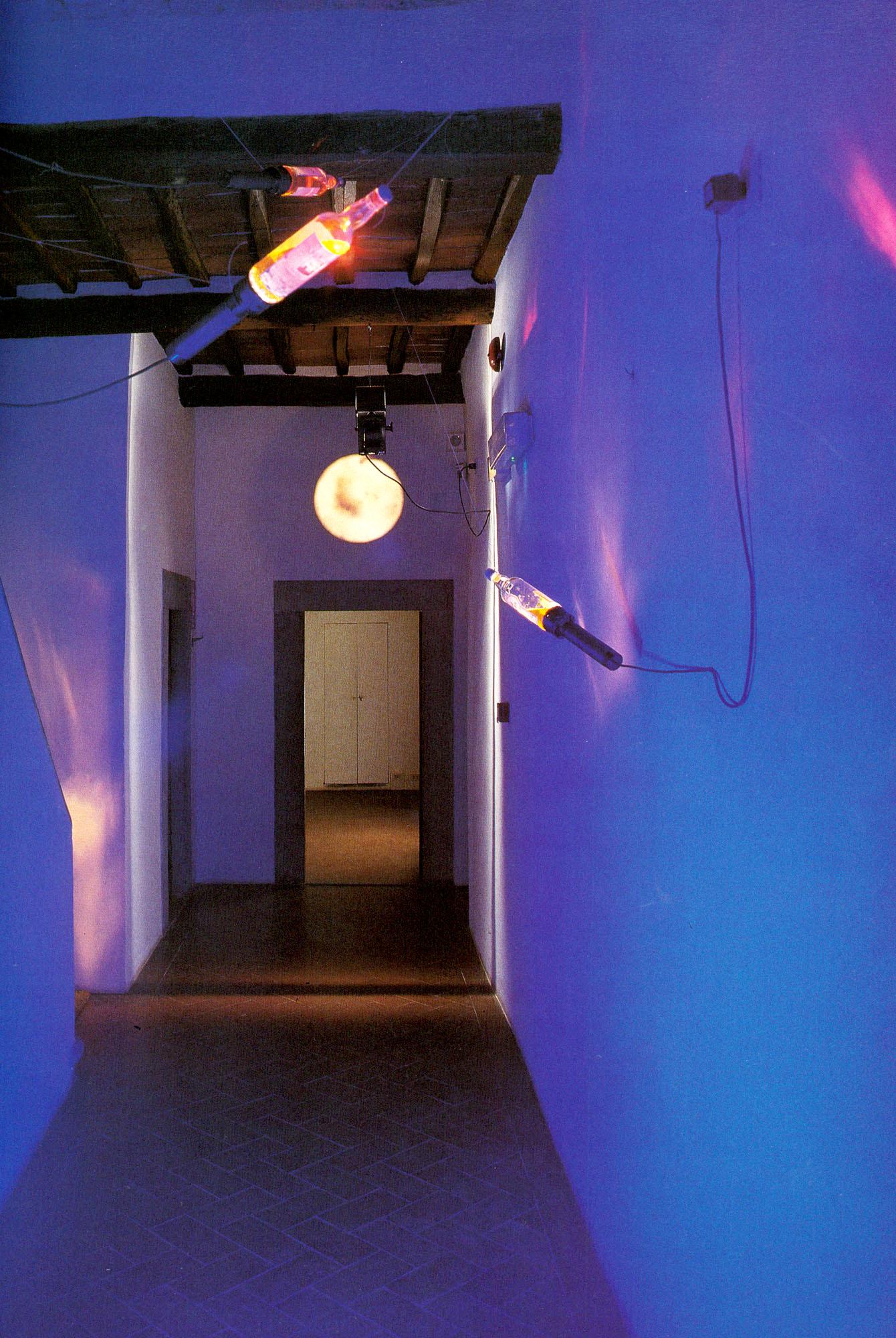 MARIO AIRÒ, Le Bleu de ciel: MARIO AIRÒ (1961) Le Bleu de ciel 1993 Installation comprised by three flashlights, three whiskey bottles, a tape, a video recorder and a 25-inch television. The installation is not comprised by