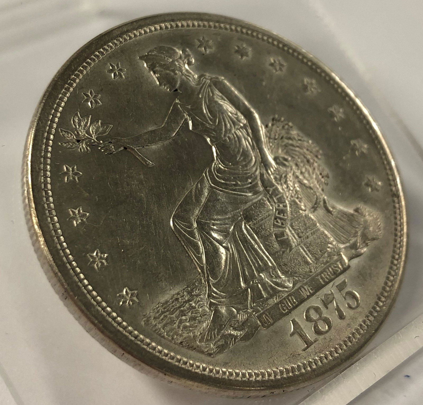 1875-S TRADE SILVER DOLLAR MS63: BACK AROUND 1986, I WAS A COIN DEALER WORKING FULL-TIME IN BEVERLY HILLS AT 8500 WILSHIRE BOULEVARD ON THE EIGHTH FLOOR. ONE OF THE MARKETING GUYS BROUGHT IN A CARD AND SAID "THIS OLD GUY HAS TOO MANY
