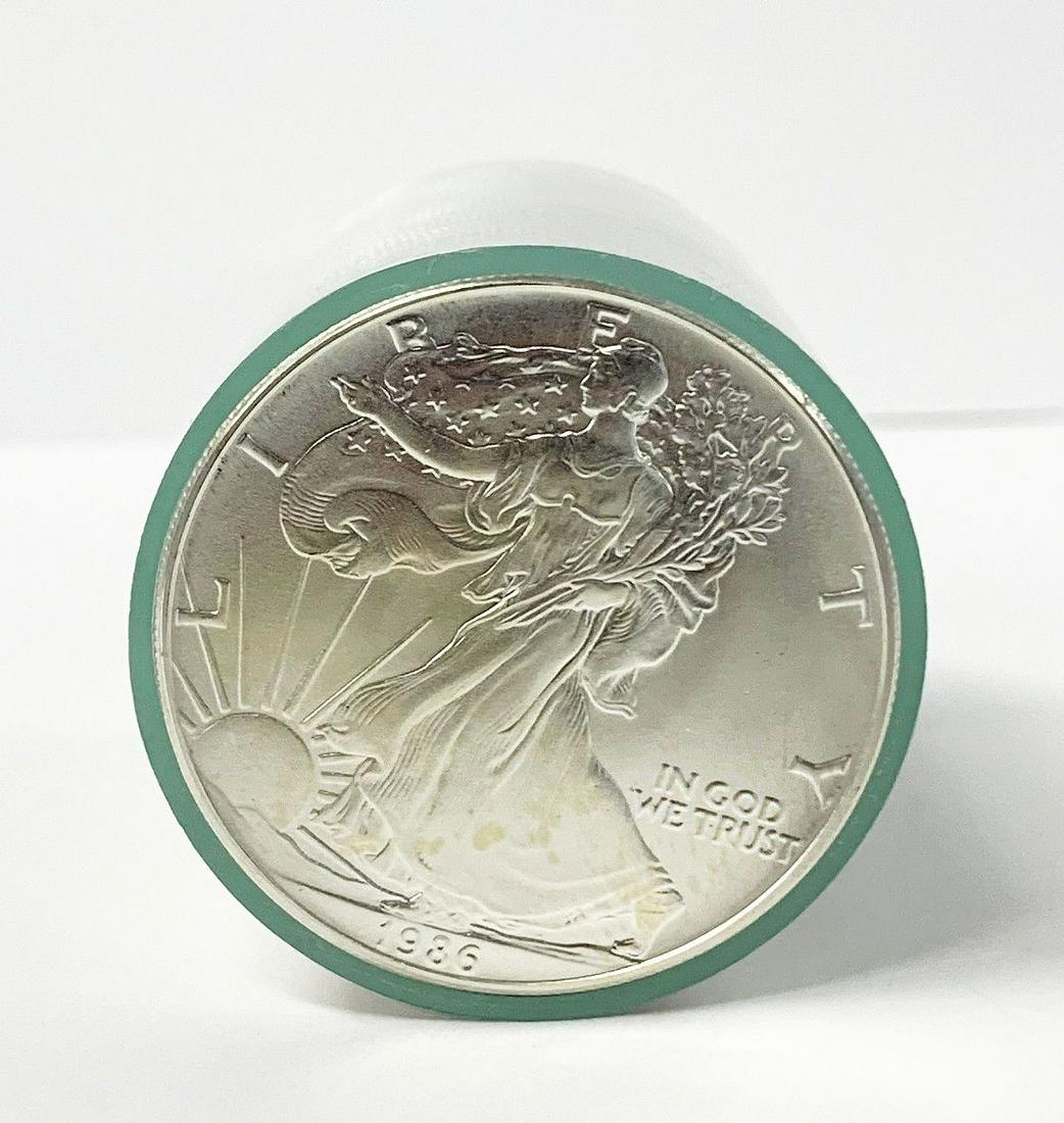 ORIGINAL ROLL 1986 AMERICAN SILVER EAGLES: ONE OF OUR CONSIGNORS SENT IN AN ORIGINAL 1986 MONSTER BOX CONTAINING 25 ROLLS THAT WERE ORIGINAL LIKE THIS ONE. THE EXAMPLE HERE IS HOW THE VERY FIRST SILVER EAGLE WAS DELIVERED FROM THE US MINT WAY 