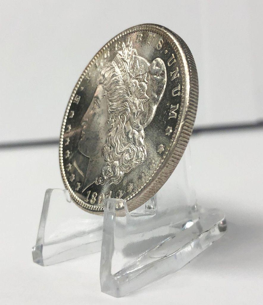 1897-S MORGAN MS64+ POSSIBLE MINT ERROR: 1897-S MORGAN SILVER DOLLAR MS64+ POSSIBLE MINT ERROR THIS LOOKS LIKE A FOREIGN SUBSTANCE GOT INTO THE DYE AND STRUCK INTO THE PLANCHET UPON STRIKING THIS LINE ON THIS COIN WINNER SHALL RECEIVE EXACT 