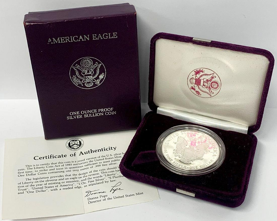 1ST YR PROOF 1986 SILVER EAGLE WITH BOX & COA: FIRST YEAR PROOF 1986 AMERICAN SILVER EAGLE WITH BOX AND COA WINNER SHALL RECEIVE THE EXACT COIN SHOWN HERE WITH THE BOX AND COA