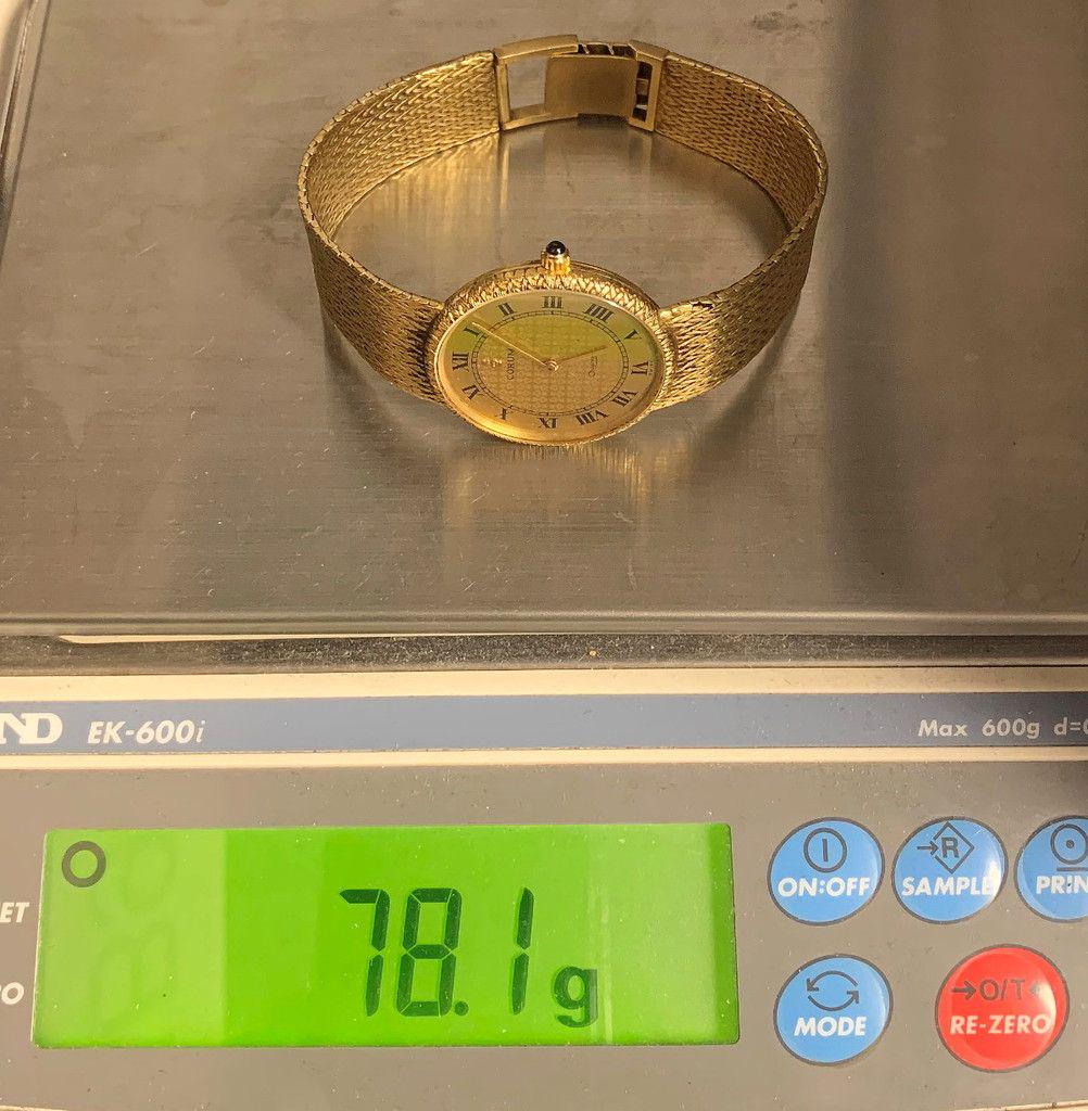CLASSIC CORUM WRIST WATCH 18K YELLOW GOLD: THE WATCH IS IN GOOD WORKING ORDER EXCEPT THAT IT NEEDS A BETTERY. IT IS, AS YOU CAN SEE, ENGRAVED HANDSOMELY. IT IS IN EXCELLENT CONDITION.THE GRAND TOTAL WEIGHT OF THIS WATCH IS 78.1 GRAMS. THE BAND