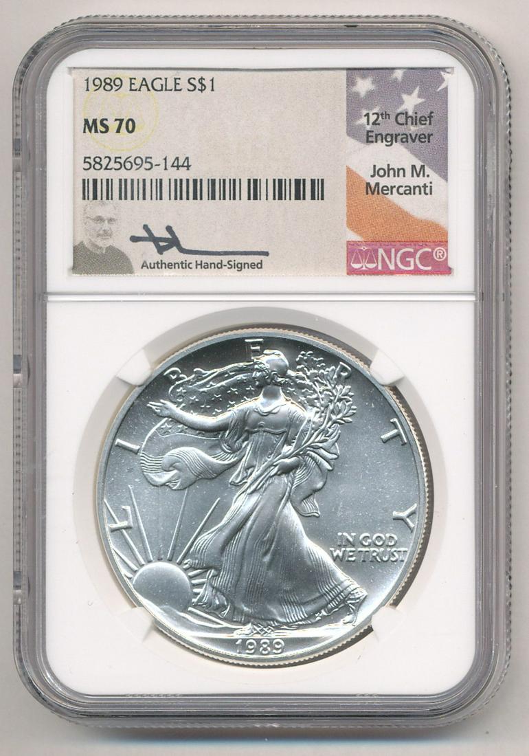 1989 SILVER EAGLE NGC MS 70 "JOHN M. MERCANTI LABEL": JOHN M. MERCANTI SIGNATURE LABEL COINS HAVE PROVEN TO BE IN HIGH DEMAND. JOHN M. MERCANTI, THE 12TH CHIEF ENGRAVER OF THE UNITED STATES MINT, IS THE MOST FAMOUS U.S. COIN ENGRAVER OF THE MODERN ERA. M