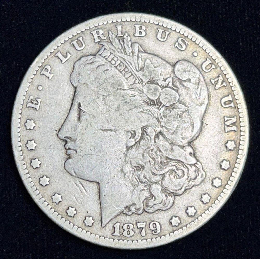 1879-S Rev. of 78 Morgan Silver Dollar Fine: This lot is for (1) Morgan Silver Dollar. This single coin for sale in this lot originated from the album shown here, which is how it was collected and stored for years. By order of consignor there is