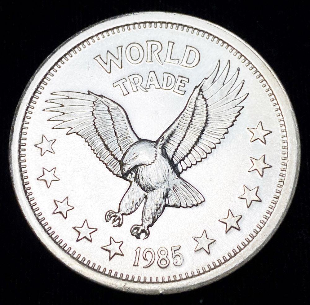1985 World Trade Unit 1 oz Silver: Winner shall receive the exact coin shown here. (RR/B)