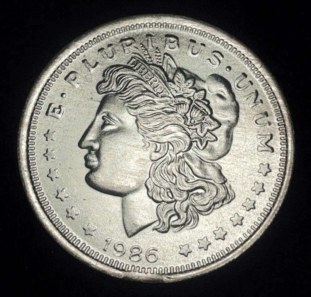 1986 Morgan Dollar Design 1 ozt .999 Silver Trade Unit: Winner shall receive the exact coin shown here. (JM/B)
