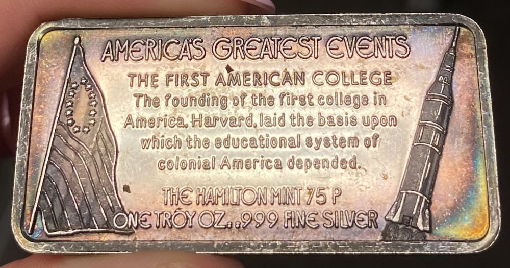 Toned Hamilton Mint "Establishment Of Harvard" 1 ozt .999 Silver Bar: Winner shall receive the exact bar shown here. (EP/B)
