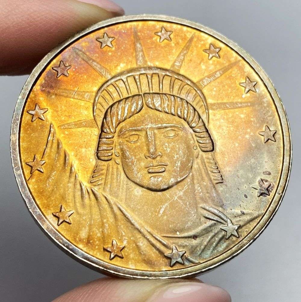 Toned Statue Of Liberty 1 ozt .999 Silver: Winner shall receive the exact coin shown here. (RR/B)