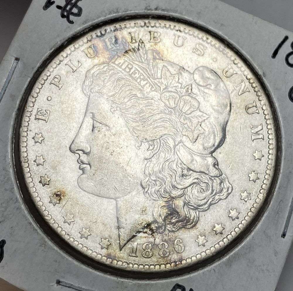 1886-O Morgan Silver Dollar AU50: Winner shall receive the exact coin shown here. (RR)