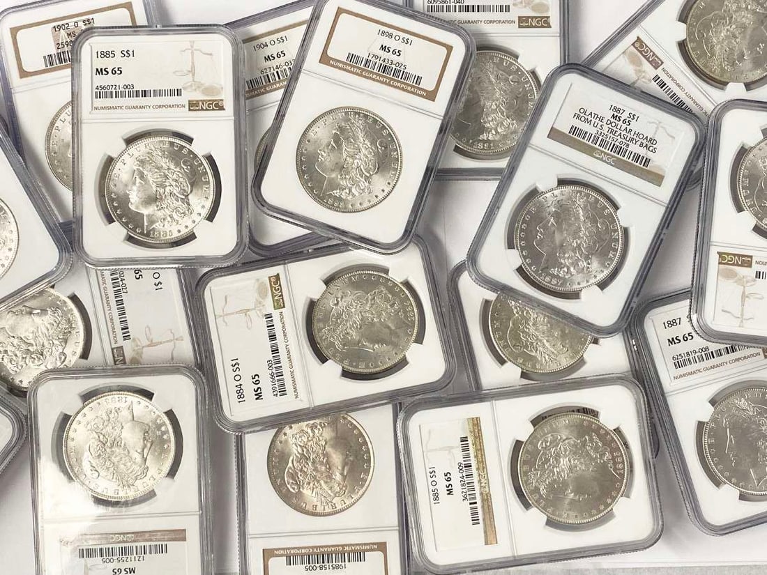 (100) Mixed Date & MM NGC MS65 Morgan Silver Dollars: Winner of auction shall receive a lot of (100-coins) Morgan Silver Dollars NGC MS65, precisely resembling the coins shown in pictures. Note: This is a stock photo. Your (100-coins) will be hand-picked