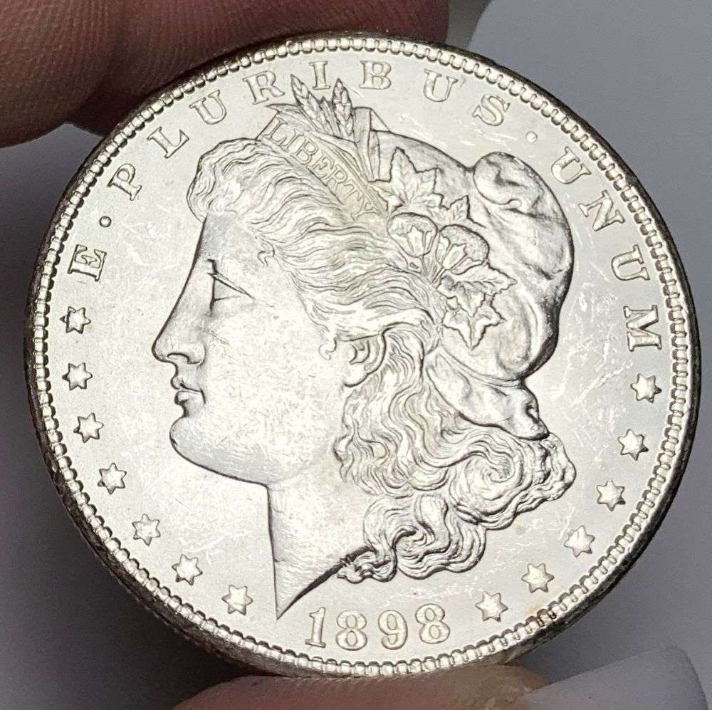 1898-O Morgan Silver Dollar MS63: This consignment, we hope to offer over time across our various Whatnot channels, with the best material featured in our Wednesday auctions. We hope to be done with this stuff by the beginning of 2027