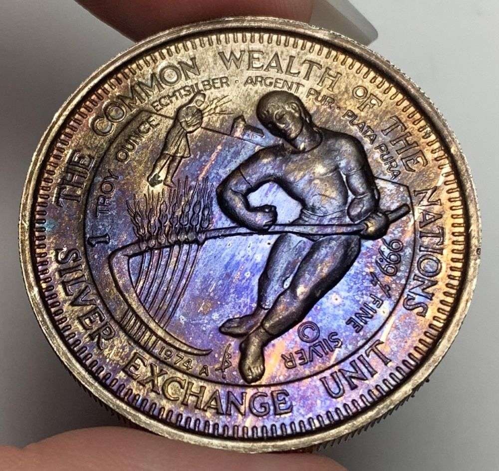 Toned 1974-A The Common Wealth Of The Nations International Exchange Unit 1 ozt .999 Silver: Winner shall receive the exact coin shown here. (MR/RB)