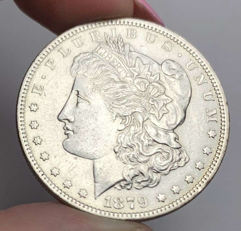 1879-O Morgan Silver Dollar AU58: This is (1) coin from a book that we received along with the heavy black book of silver dollars. Winner shall receive the exact coin shown here. (MR/EB)