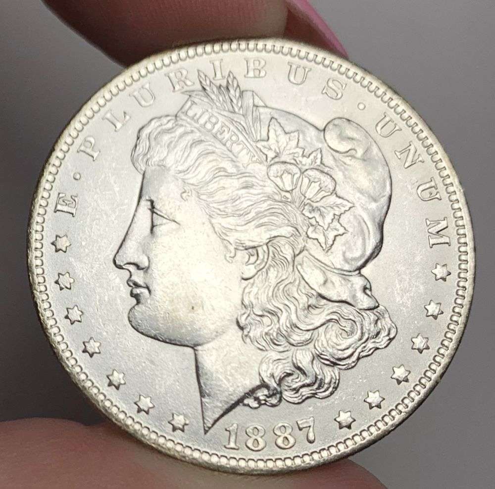 1887-O Morgan Silver Dollar MS64: This is (1) coin from a book that we received along with the heavy black book of silver dollars. Winner shall receive the exact coin shown here. (MR/EB)