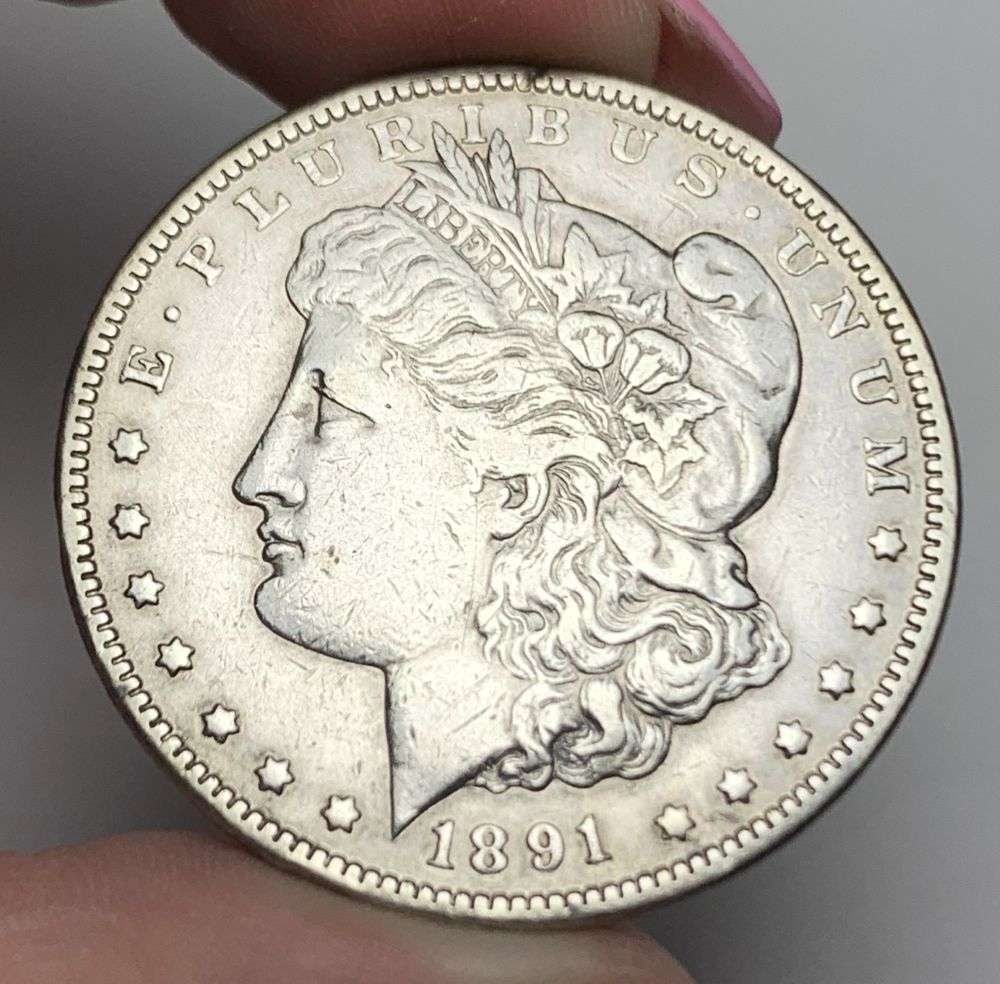 1891-CC Morgan Silver Dollar XF: This is (1) coin from a book that we received along with the heavy black book of silver dollars. Winner shall receive the exact coin shown here. (MR/LBB)