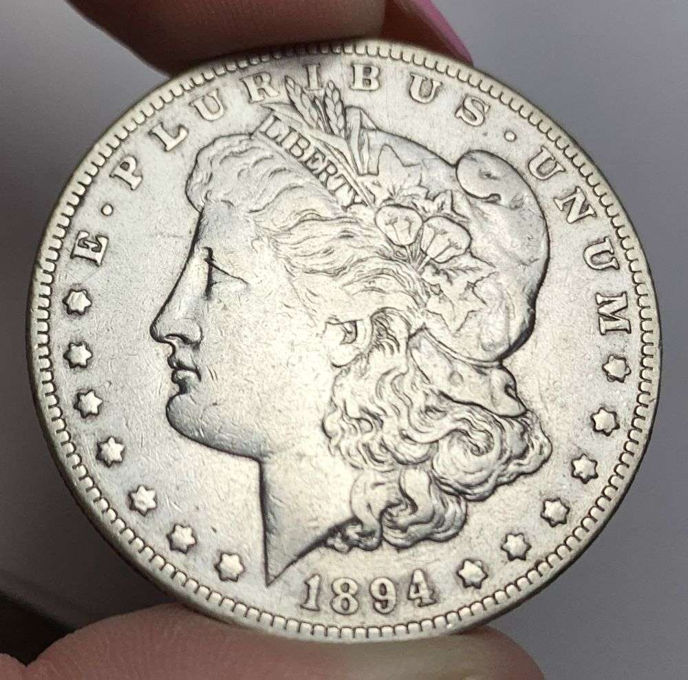 1894-O Morgan Silver Dollar VF: This is (1) coin from a book that we received along with the heavy black book of silver dollars. Winner shall receive the exact coin shown here. (MR/PB)