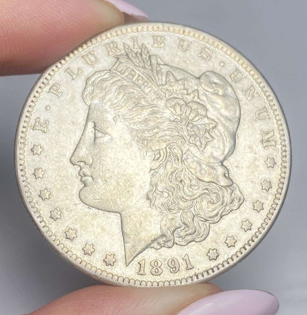 1891-CC Morgan Silver Dollar AU55: This consignment, we hope to offer over time across our various Whatnot channels, with the best material featured in our Wednesday auctions. We hope to be done with this stuff by the beginning of 2027