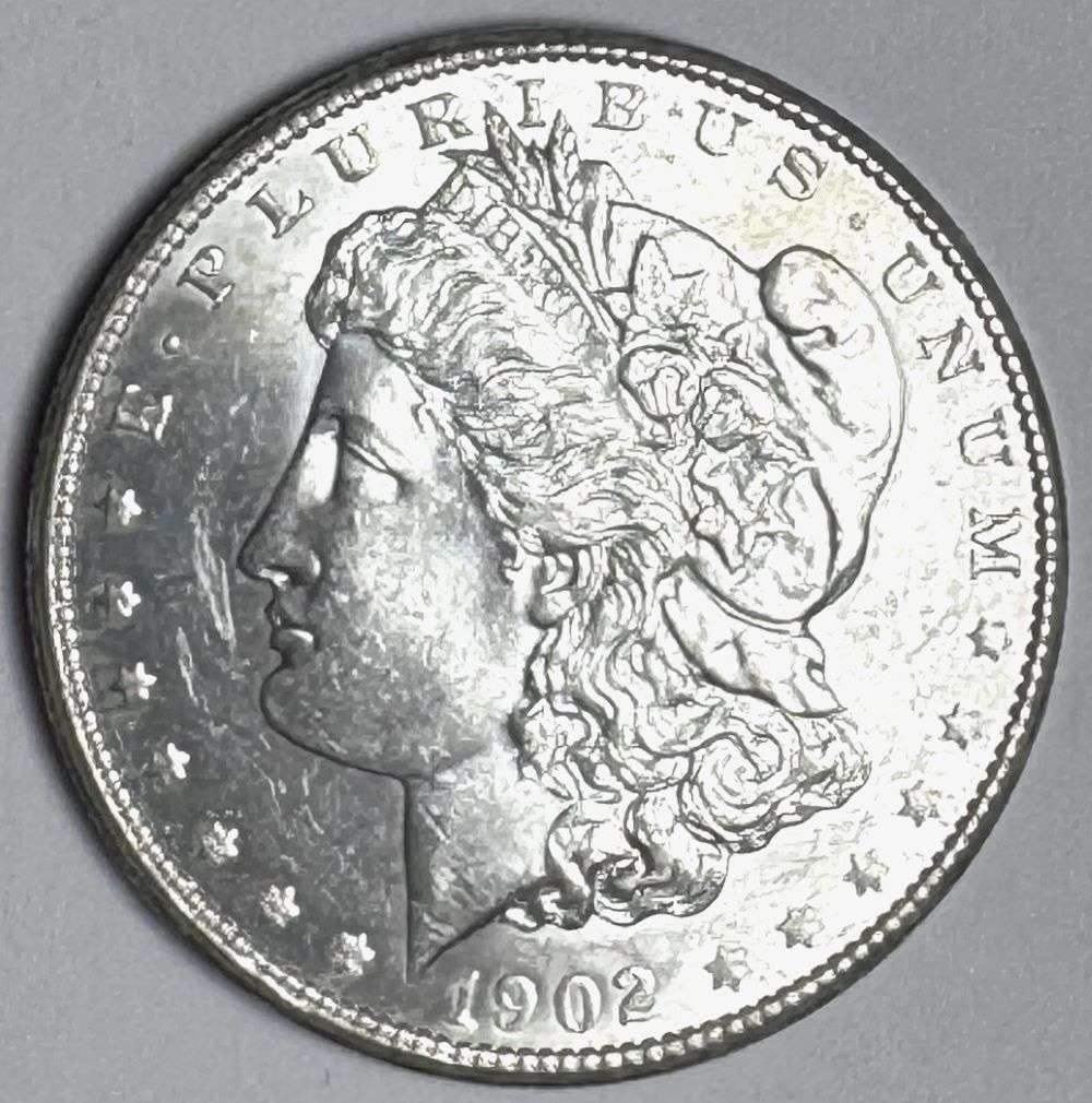 1902-O Morgan Silver Dollar MS65: "This is the story about two coin dealers, a partnership. One,the largest bullion dealer north of San Francisco, and the other, the largest rare coin dealer north of San Francisco. Together, their sho