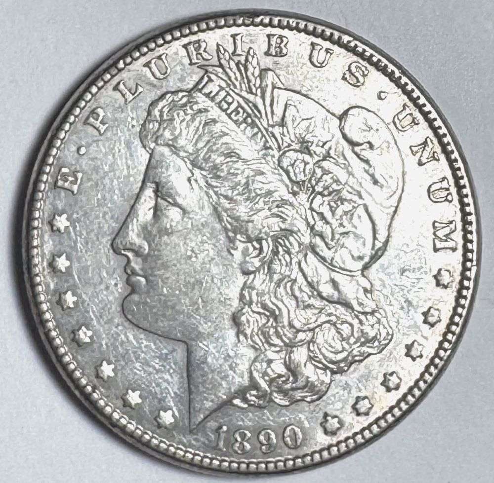 1890-CC Morgan Silver Dollar AU55: This is the story about two coin dealers, a partnership. One,the largest bullion dealer north of San Francisco, and the other, the largest rare coin dealer north of San Francisco. Together, their shop