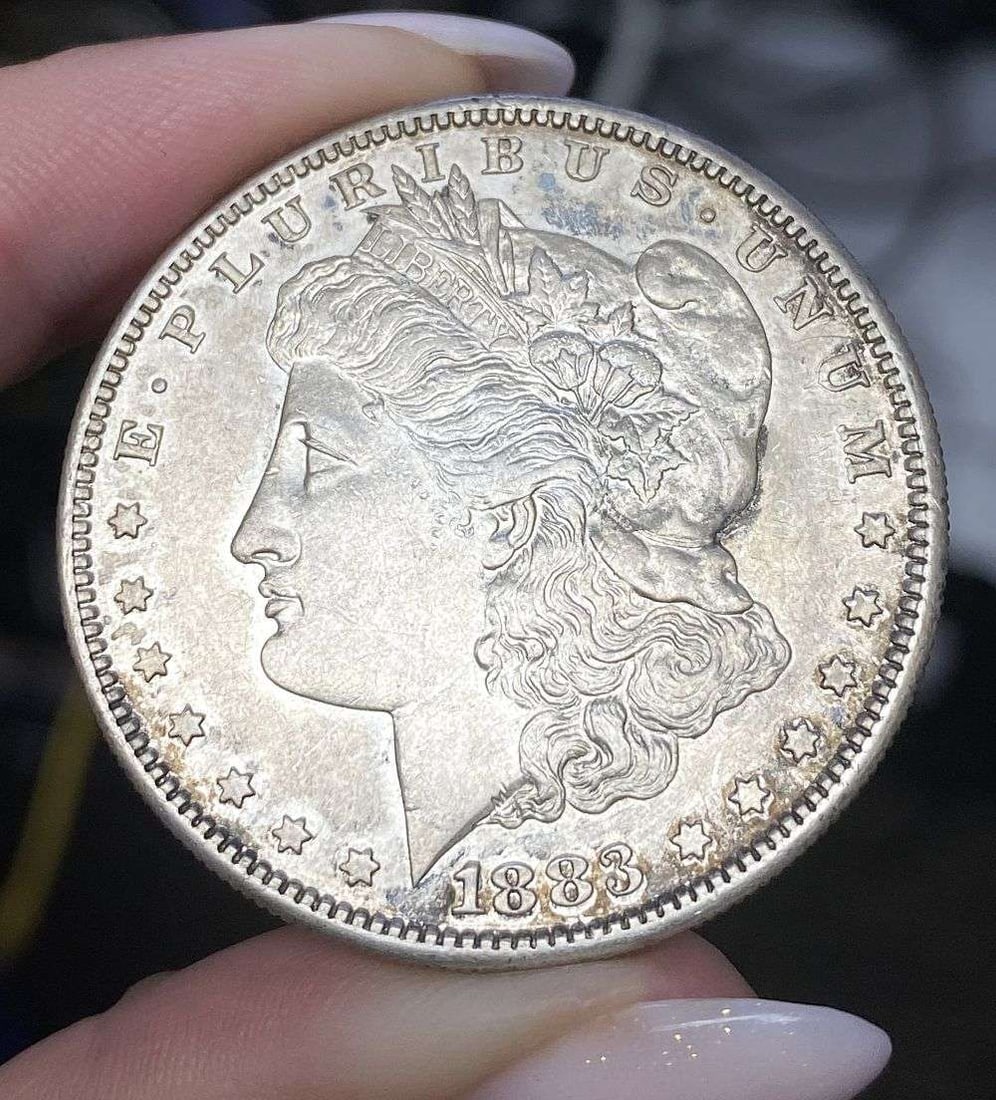 1883-S Morgan Silver Dollar MS62 Details: This is the story about two coin dealers, a partnership. One,the largest bullion dealer north of San Francisco, and the other, the largest rare coin dealer north of San Francisco. Together, their shop