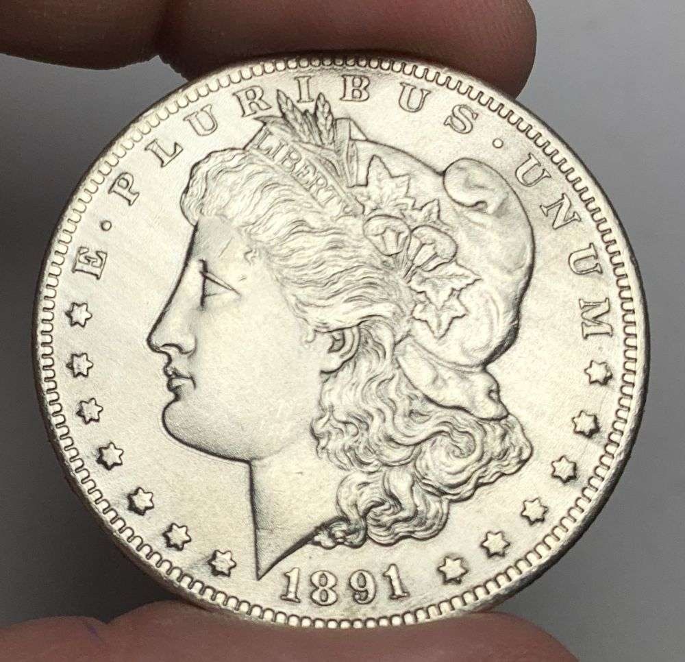 1891-CC Morgan Silver Dollar MS62 Details: This is the story about two coin dealers, a partnership. One, the largest bullion dealer north of San Francisco, and the other, the largest rare coin dealer north of San Francisco. Together, their sho