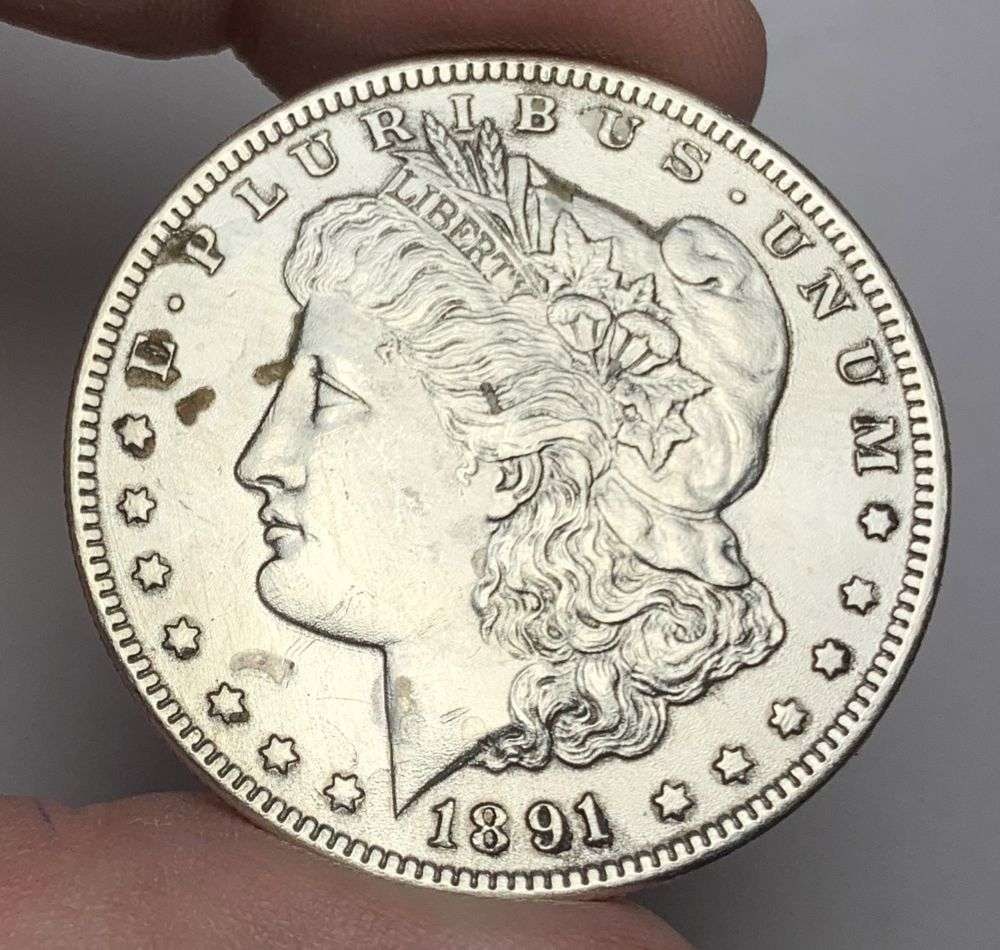 1891-CC Morgan Silver Dollar MS62 Details: This is the story about two coin dealers, a partnership. One, the largest bullion dealer north of San Francisco, and the other, the largest rare coin dealer north of San Francisco. Together, their sho