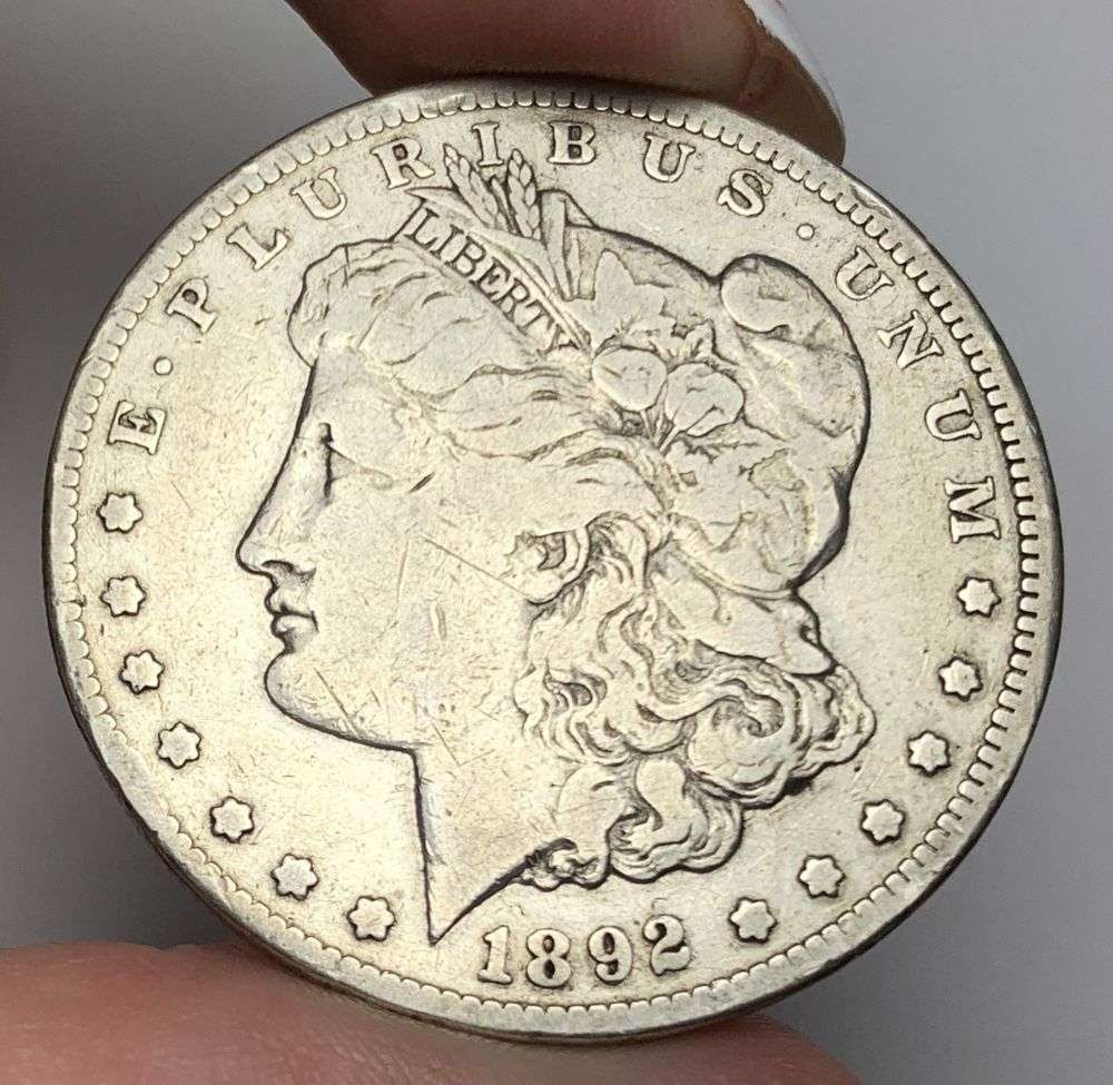 1892-CC Morgan Silver Dollar VF: This is the story about two coin dealers, a partnership. One, the largest bullion dealer north of San Francisco, and the other, the largest rare coin dealer north of San Francisco. Together, their sho