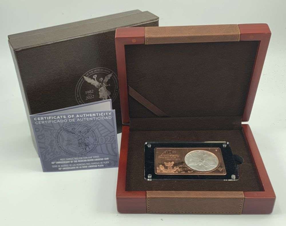 2022 40th Anniversary Mexican Libertad 1 ozt Silver encased in a 1 ozt Commemorative Bar: This 2022 commemorative piece celebrates the 40th anniversary of the legendary Mexican Silver Libertad coin, originally introduced by the Banco de México in 1982. As part of a popular world bullion s
