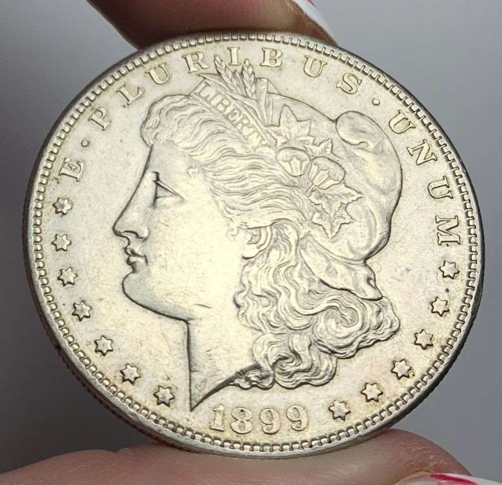 1899-S Morgan Silver Dollar AU53: This is the story about two coin dealers, a partnership. One, the largest bullion dealer north of San Francisco, and the other, the largest rare coin dealer north of San Francisco. Together, their sho