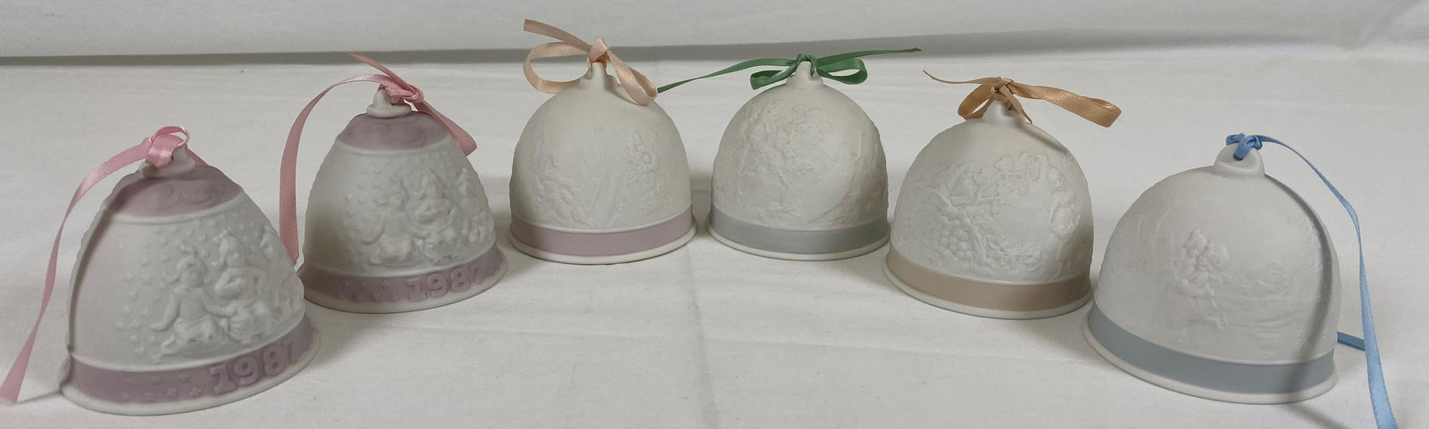 Retired Lladro Christmas Ornament Bells Porcelain: Beautiful lladro white porcelain Christmas bells. All bells are in overall great condition. 2 bells from 1987, sculpted by Jose Roig. 1 from 1991 sculpted by Francisco Polope. 1 from 1992 sculpted by