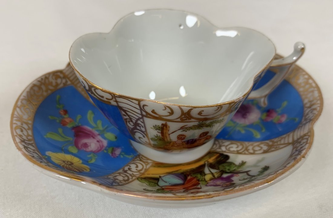 Antique Carl Thieme Cup & Saucer: Antique Carl Thieme Cup & Saucer hand painted hand painted German Meissen or Dresden ? Depicts a man and women sitting on a log playing music Colors are blue white and a gold trim Overall in good cond